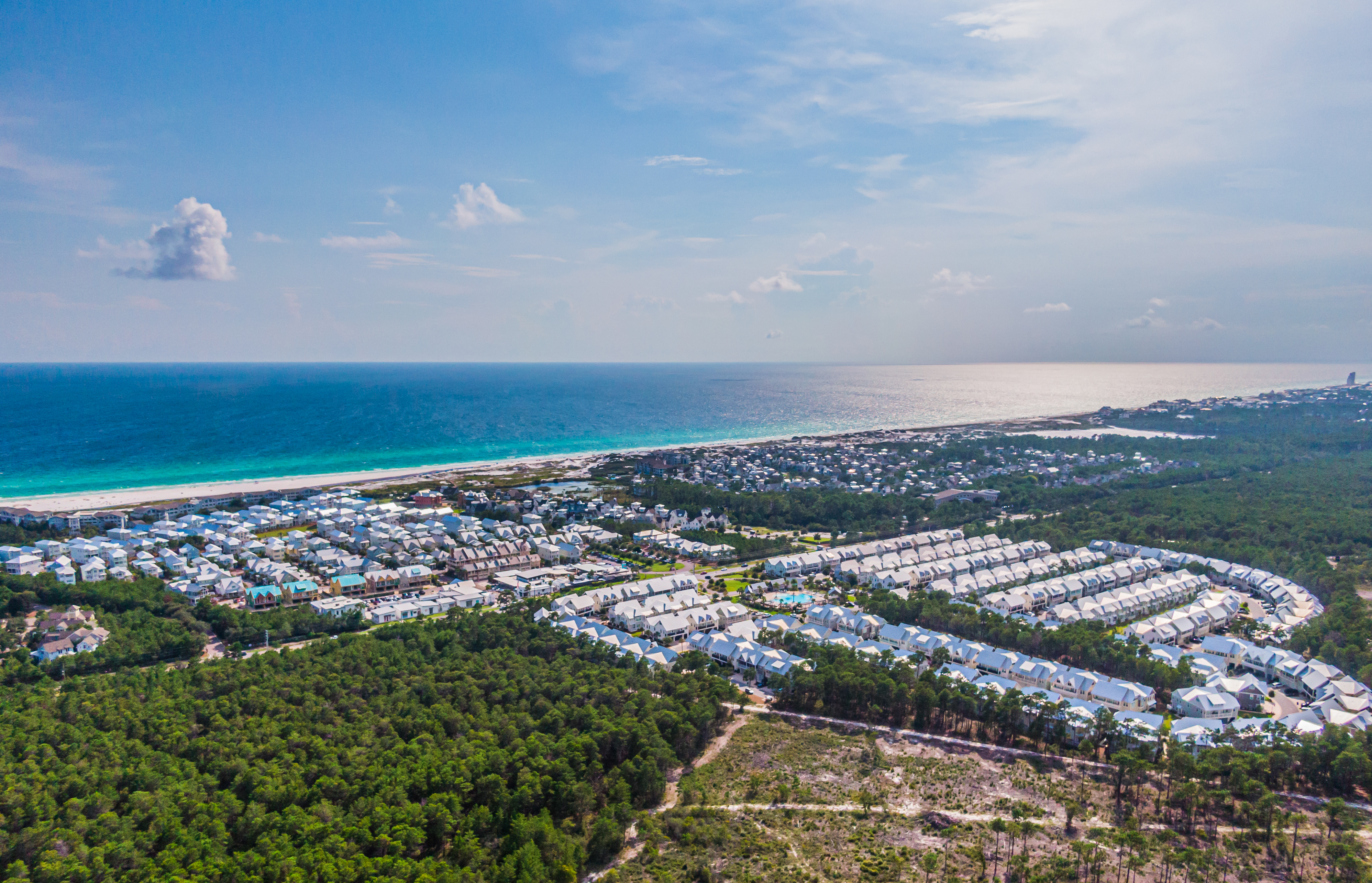 An aerial view of the Prominence community with the gulf in the background in the late afternoon